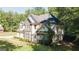 Well-maintained two-story home showcasing stone and siding, plus lush green landscaping at 1231 Hillview Rd, Hampton, GA 30228