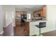 Well-equipped kitchen with wooden cabinets, breakfast bar, and easy access to living areas at 1231 Hillview Rd, Hampton, GA 30228