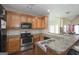Open kitchen design with wood cabinets, breakfast bar, and stainless steel appliances at 1231 Hillview Rd, Hampton, GA 30228