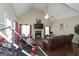 Spacious living room featuring a vaulted ceiling, fireplace, hardwood floors, and comfortable seating at 1231 Hillview Rd, Hampton, GA 30228
