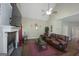 Inviting living room featuring a vaulted ceiling, fireplace, hardwood floors, and comfortable leather seating at 1231 Hillview Rd, Hampton, GA 30228