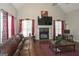 Inviting living room featuring a vaulted ceiling, fireplace, hardwood floors, and lots of natural light at 1231 Hillview Rd, Hampton, GA 30228