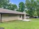 Lovely backyard featuring a spacious lawn, mature trees, and a rear patio area for outdoor entertaining at 110 Thompson Blvd, Stockbridge, GA 30281