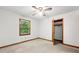 Bedroom with baseboard trim, large window, ceiling fan and closet at 110 Thompson Blvd, Stockbridge, GA 30281