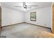 Neutral bedroom features a ceiling fan, window, and carpeted floor at 110 Thompson Blvd, Stockbridge, GA 30281