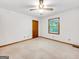 A cozy bedroom has a ceiling fan, neutral carpet, and a window bringing in soft, natural light at 110 Thompson Blvd, Stockbridge, GA 30281