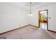 Carpeted dining room featuring an open door to a kitchen area at 110 Thompson Blvd, Stockbridge, GA 30281