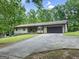 Single-story home with a two-car garage, a well-maintained lawn, and classic architectural details, providing a welcoming curb appeal at 110 Thompson Blvd, Stockbridge, GA 30281