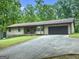 Quaint single-Gathering home with a long driveway, attached garage, and well-maintained lawn at 110 Thompson Blvd, Stockbridge, GA 30281