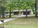 Charming single-story home with a two-car garage, mature trees, and a spacious driveway, set in a peaceful neighborhood at 110 Thompson Blvd, Stockbridge, GA 30281