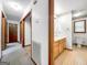 Hallway view showing doorways, access to a full bathroom, and neutral color palette at 110 Thompson Blvd, Stockbridge, GA 30281