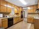 Traditional eat-in kitchen with wooden cabinets, tile backsplash, and modern appliances, providing a functional and inviting space at 110 Thompson Blvd, Stockbridge, GA 30281
