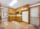 A bright kitchen with wood cabinets, complemented by neutral countertops and flooring, is ideal for meal preparation and gatherings at 110 Thompson Blvd, Stockbridge, GA 30281