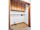 A charming laundry room features checkered tile flooring and useful overhead wood cabinetry at 110 Thompson Blvd, Stockbridge, GA 30281