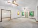 Living room area with neutral color palette, baseboard trim, and large windows at 110 Thompson Blvd, Stockbridge, GA 30281