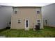 Exterior view of the rear of the house, showing the siding, windows, and access to the backyard at 1579 Leonard St, Hampton, GA 30228