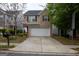Two-story home with a brick facade and a two-car garage, complemented by a well-kept lawn and mature trees at 1579 Leonard St, Hampton, GA 30228