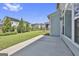 Concrete patio with a spacious backyard, green grass and neighborhood view in the background at 307 Owenberg Trce, Peachtree City, GA 30269