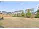 Picturesque backyard featuring a wooden fence, healthy grass, and lush green shrubbery for seclusion at 307 Owenberg Trce, Peachtree City, GA 30269