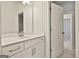 Bathroom vanity with a white countertop and cabinetry and a bright mirror at 307 Owenberg Trce, Peachtree City, GA 30269
