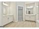 Bathroom featuring dual sink vanity, a view of a bedroom, and a soaking tub at 307 Owenberg Trce, Peachtree City, GA 30269