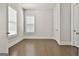 Bright bedroom with hardwood floors, white trim, neutral walls, and ample natural light from two windows at 307 Owenberg Trce, Peachtree City, GA 30269