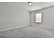Clean bedroom with neutral walls and carpeting, two windows for natural light and base trim at 307 Owenberg Trce, Peachtree City, GA 30269