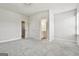 Bright bedroom with neutral walls and carpet, and multiple doors for closets and bathroom at 307 Owenberg Trce, Peachtree City, GA 30269