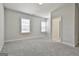 Bedroom with neutral walls and carpet, base trim, two windows and doors to closet and bath at 307 Owenberg Trce, Peachtree City, GA 30269