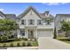 Charming two-story home with well-manicured lawn, two-car garage, neutral paint, and a welcoming front porch at 307 Owenberg Trce, Peachtree City, GA 30269