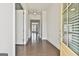 Bright foyer with dark hardwood floors, white trim, and view into the sun-lit living areas at 307 Owenberg Trce, Peachtree City, GA 30269
