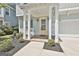 Inviting front porch with brick floor, white columns, and a bright yellow front door at 307 Owenberg Trce, Peachtree City, GA 30269