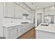Beautiful kitchen features white cabinets, modern appliances, and a stylish tile backsplash at 307 Owenberg Trce, Peachtree City, GA 30269
