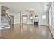 Open concept living room with staircase, fireplace, and ample natural light at 307 Owenberg Trce, Peachtree City, GA 30269