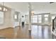 Spacious living room with hardwood floors, fireplace, wainscoting, and an abundance of natural light at 307 Owenberg Trce, Peachtree City, GA 30269