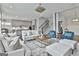 Open concept living room featuring kitchen, stairs, and stylish furnishings at 307 Owenberg Trce, Peachtree City, GA 30269