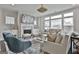 Comfortable living room with fireplace, large windows, stylish furniture, and decor at 307 Owenberg Trce, Peachtree City, GA 30269