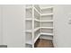 Bright, white pantry area with custom shelving provides plenty of storage at 307 Owenberg Trce, Peachtree City, GA 30269