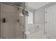 Bright bathroom featuring a shower, separate tub, and linen tower at 2698 Pleasant Grove Church Rd, Villa Rica, GA 30180