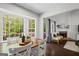 A breakfast nook with a wood table and white chairs sits adjacent to a living room with a fireplace at 2698 Pleasant Grove Church Rd, Villa Rica, GA 30180