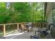 Outdoor deck with chairs and table overlooking a private wooded backyard at 2698 Pleasant Grove Church Rd, Villa Rica, GA 30180