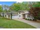 Charming home with mature landscaping, attached garage, and lovely curb appeal at 2698 Pleasant Grove Church Rd, Villa Rica, GA 30180