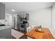 Clean kitchen with stainless steel appliances, wood flooring, and a modern dining set at 2698 Pleasant Grove Church Rd, Villa Rica, GA 30180