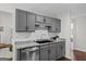 Updated kitchen features gray cabinets, stainless steel appliances, granite countertops, and a tiled backsplash at 2698 Pleasant Grove Church Rd, Villa Rica, GA 30180