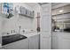 Well-equipped laundry room with modern appliances and storage shelves at 2698 Pleasant Grove Church Rd, Villa Rica, GA 30180