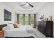 This primary bedroom features a trey ceiling, ceiling fan, ensuite bathroom, and wooded view at 2698 Pleasant Grove Church Rd, Villa Rica, GA 30180