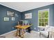 Modern home office with two monitors, a large window, and blue walls at 2698 Pleasant Grove Church Rd, Villa Rica, GA 30180