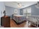 Comfortable bedroom featuring wood floors, ceiling fan, and bright natural light at 1112 Haver Ct, Mcdonough, GA 30252