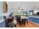 An open dining room features wood floors, light blue walls, and a ceiling fan over the dining table at 1112 Haver Ct, Mcdonough, GA 30252