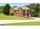 Inviting brick home with manicured lawn, charming front entrance, and well-maintained landscaping at 1112 Haver Ct, Mcdonough, GA 30252